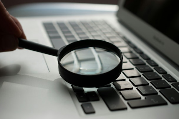 A magnifying glass on a laptop