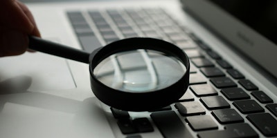 A magnifying glass on a laptop