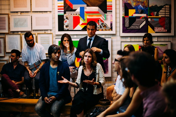 A woman talking in front of a focus group 