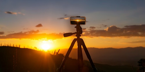 A phone set up to film a sunset