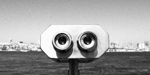 A black-and-white photograph of a binocular-style viewfinder