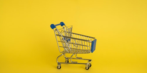 A trolley against a yellow background (representing retail media)