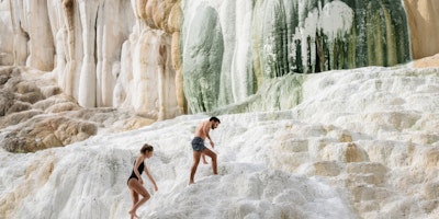 Two people hiking across a quarry 