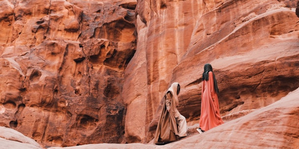 Two people hiking across a mountain