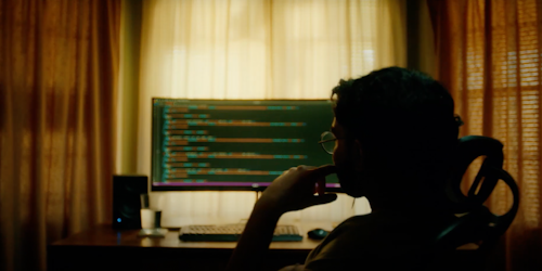 Back of boy's head with computer screen in front of him