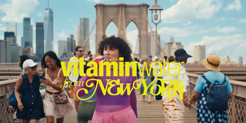 girl drinking VitaminWater on the brooklyn bridge